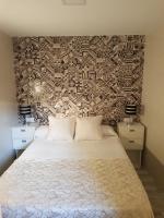 A bed or beds in a room at Apartamentos Sueños de Toledo