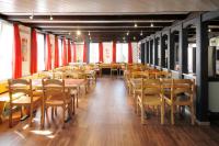 Un comedor con mesas y sillas de madera. en Hotel Krone, en Attinghausen