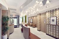 a lobby with a waiting area with chairs and tables at Artezen Hotel in New York