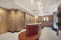 a lobby with a chair and a bar in it at Artezen Hotel in New York