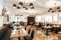 a dining room with tables and chairs at Hotel Königssee in Schönau am Königssee