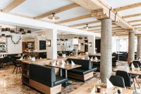 a restaurant with tables and chairs and a bar at Hotel Königssee in Schönau am Königssee