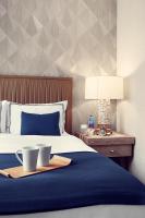 a bedroom with a bed with two cups on a tray at Artezen Hotel in New York