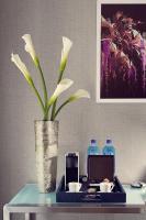 a vase with a plant on a table with drinks at Artezen Hotel in New York