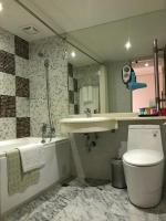 a bathroom with a sink and a toilet and a bath tub at Link World Hotel in Taipei