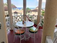 a white table and chairs on a balcony at #D1 castle STUDIO WIFI KING bed Ocho Rios Jamaica in Ocho Rios
