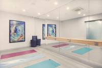 a room with paintings on the wall and mats at Artezen Hotel in New York