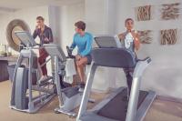 a group of people sitting on exercise bikes in a gym at Artezen Hotel in New York