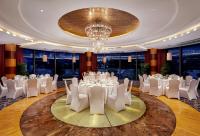 a ballroom with white tables and chairs and a chandelier at Park Plaza Beijing Wangfujing in Beijing