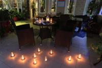a table and chairs with lights on the floor at Avica Homestay in Wujie