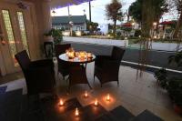 a table and chairs on a patio with lights at Avica Homestay in Wujie