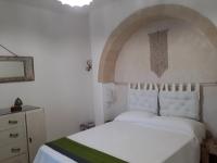 A bed or beds in a room at Trullo Cime Bianche