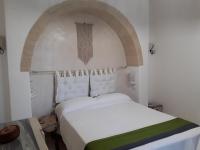 A bed or beds in a room at Trullo Cime Bianche