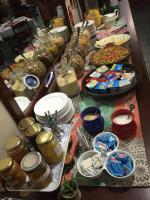 a table topped with plates and bowls of food at Kaapsche Hoop Gastehuis in Kaapsehoop