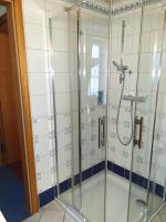 a shower with glass doors in a bathroom at Hotel Piccolo in Schleiz