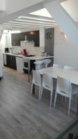 a kitchen with a table and chairs in a room at Le Metz, Duplex, 2 Chambres in Le Touquet-Paris-Plage