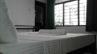 a bed with two towels on it with a window at Water Front Home Stay and Resort in Anuradhapura