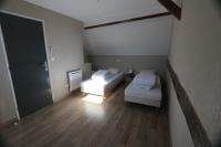 a small room with two beds and a mirror at Apparts Gites Cholet centre in Cholet