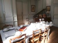 a white table with chairs and a book on it at La Maison XVIIIe in Moulins