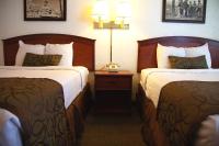 a hotel room with two beds and a lamp at Bryce View Lodge Part of the Ruby's Inn Resort in Bryce Canyon