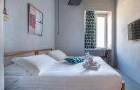 A bed or beds in a room at Pietra - The Italian Stay Collection