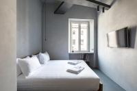 A bed or beds in a room at Pietra - The Italian Stay Collection