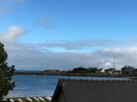 a view of a body of water with a town at Le Gîte du Port in Roscoff