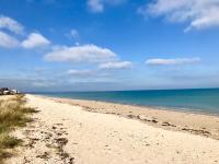 a sandy beach with the ocean in the background at La Bichurie in Feugères