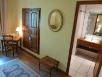 a bathroom with a sink and a wooden door at Château de Ribourdin in Chevannes