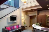 a living room with a couch with pink pillows at Best Western Hotel de la Breche in Niort