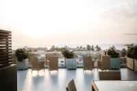 a balcony with chairs and a view of the ocean at Hotel Sico in Negombo