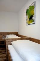 two beds in a room with a picture on the wall at City Rooms Wels - contactless check-in in Wels