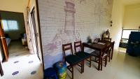 a room with a table and chairs and a brick wall at Sabai B&amp;B 澎湖船家寶民宿 in Huxi