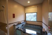 a bathroom with a tub and a window at Tangyue Resort in Tai&#39;an