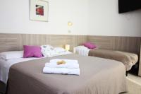 Łóżko lub łóżka w pokoju w obiekcie Hotel Verde Luna