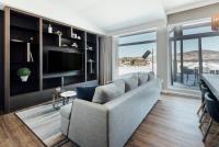 a living room with a couch and a television at Entourage sur-le-Lac in Lac-Beauport