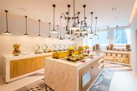 a large kitchen with chandeliers and a large island at Centara West Bay Hotel & Residences Doha in Doha