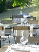 Hotel La Bastie d'Urfé في Naussac: مجموعة من الطاولات مع كؤوس النبيذ عليها