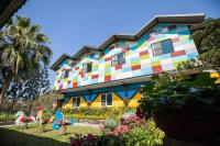a colorful house with a garden in front of it at Yushow Library Villa in Nanzhuang