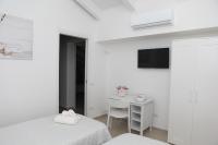 A bed or beds in a room at Rosy House - Hospitality
