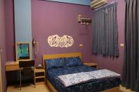 a bedroom with a bed and a desk and a mirror at The Beauty of Basalt B&amp;B in Magong