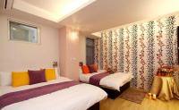 a hotel room with two beds and a window at Simplicity Sojourn Hualien in Hualien City