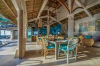 a dining room with a table and chairs at Sailing Club Resort Mui Ne in Mui Ne