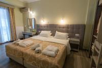 Postel nebo postele na pokoji v ubytování Aklidi Hotel