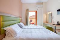 A bed or beds in a room at Hotel Aggelos Kefalonia