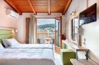 A bed or beds in a room at Hotel Aggelos Kefalonia