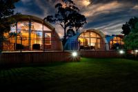 a house with two domes in a yard at night at 43 Degrees Bruny Island in Adventure Bay