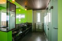 a green bathroom with two sinks and two mirrors at Blue Ocean Sunny BS in Checheng