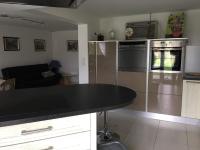 a kitchen with a black counter top in a room at AU BONHEUR in Idron