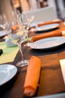 a wooden table with plates and glasses of wine at Hotel Arrope in Haro